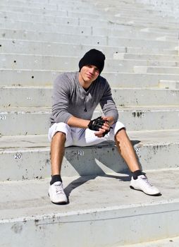 Young athletic guy in an empty stadium