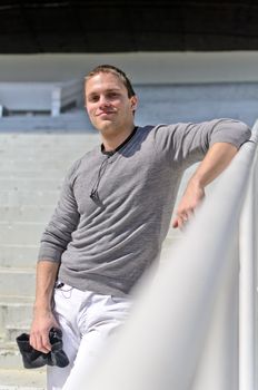 Young athletic guy in an empty stadium