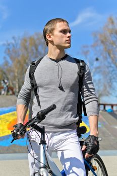 Portrait of BMX bicycle rider on urban skatepark background