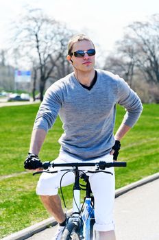 Portrait of handsome male riding a bicycle