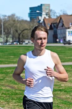 Athletic young male running around the city