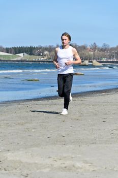 Athletic young male running on the beach