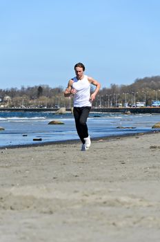 Athletic young male running on the beach