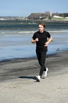 Athletic young male running on the beach