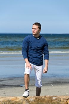 Young male standing on the beach