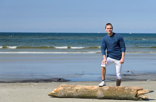 Young male standing on the beach
