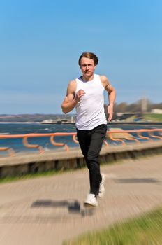Motion Blur: Athletic young male running 