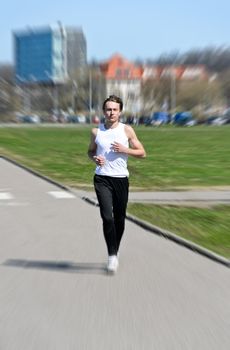 Motion Blur: Athletic young male running 