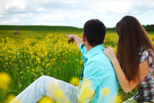 lovers hug on yellow flower field