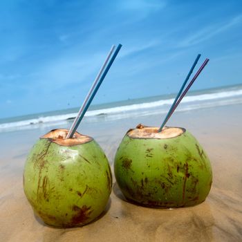 coconut cocktail on beach sand