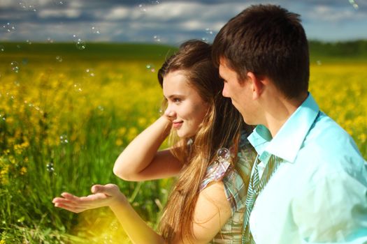 lovers hug on yellow flower field