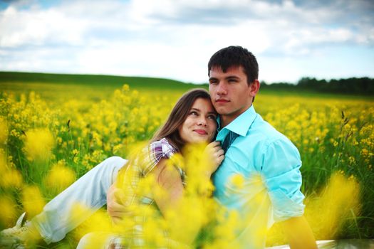 lovers hug on yellow flower field