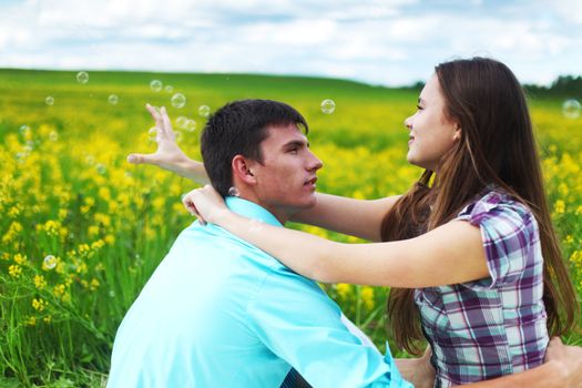 lovers hug on yellow flower field