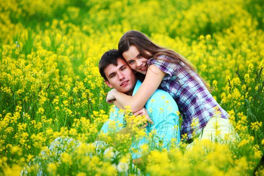 lovers hug on yellow flower field
