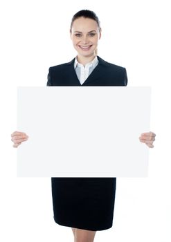 Businesswoman holding a blank poster against white background, smiling