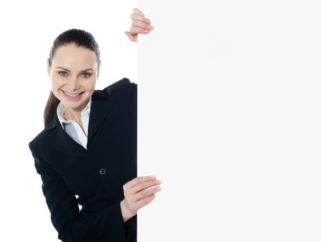 Businesswoman holding a long blank banner ad isolated over white background