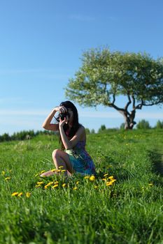 woman photographer on green grass field