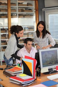 Group of office workers looking at a computer