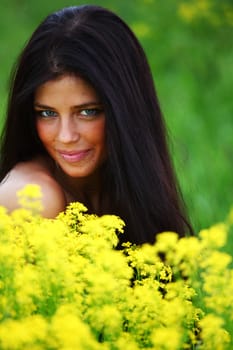 woman on oilseed field close portrait