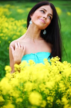 woman on oilseed field close portrait