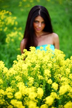 woman on oilseed field close portrait