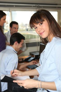 Woman taking notes in a friendly office