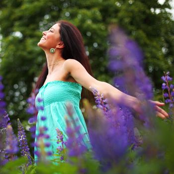 woman on pink flower field close portrait