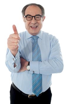 Matured businessman gesturing thumbs-up sign at you isolated on white