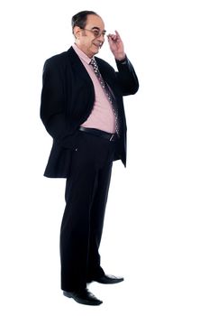 Side view of matured businessman holding his glasses isolated over white background