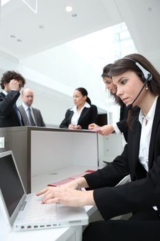 Woman working on a busy reception desk