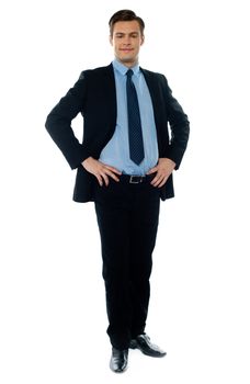 Full length view of a young businessperson posing with hands on his waist