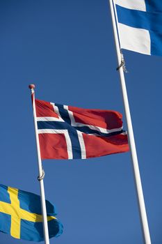 Scandinavian flags towards blue sky