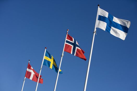 Scandinavian flags towards blue sky