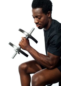 Portrait of happy fit african man working out with dumbbell