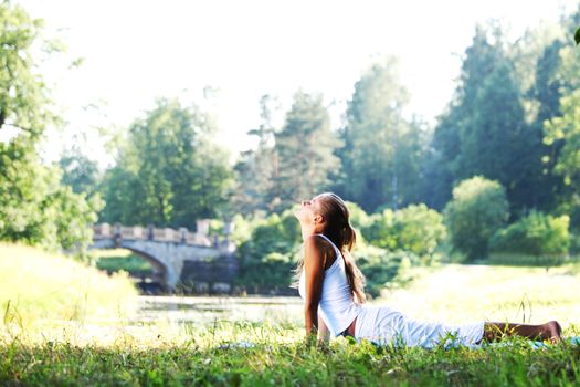 yoga woman on green park background