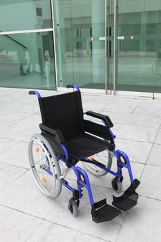 Empty wheelchair outside office building