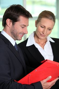Businessman and woman with folder