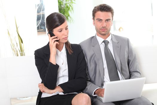 Businesscouple working in waiting area