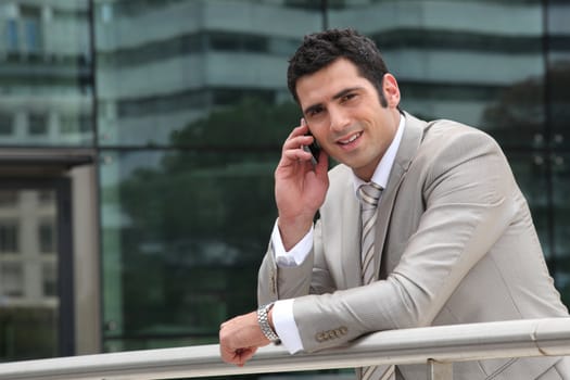 Man using a cellphone outside an office building