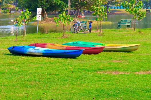 Canoe on a Still Lake on the grasses ground.