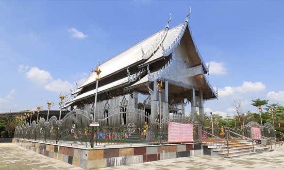 Stainless steel temple on clear blue sky in thailand.