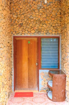 Brown door with brown wall on a stone format.