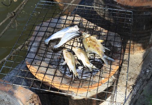 Cooking fish on the grill with antique stove.