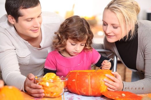 Family carving a pumpkin