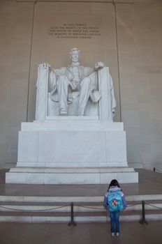 A young girl looks up - literally - to Abraham Lincoln's statue on the National Mall.