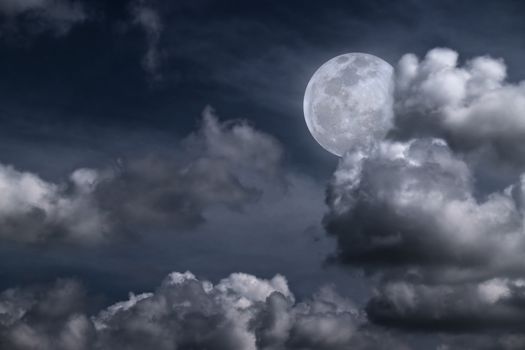 Beautiful full moon behind fantasy cloudy sky