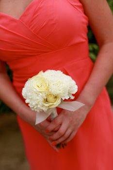 Close-up of a bridesmaid holding their wedding bouquets.