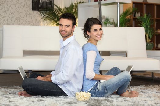 Couple sitting with laptop computers