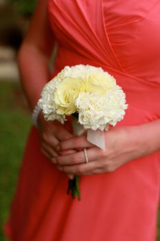Close-up of a bridesmaid holding her wedding bouquet.