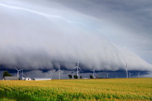 Wind turbines under a dark and ominous shelf cloud in northern Illinois.